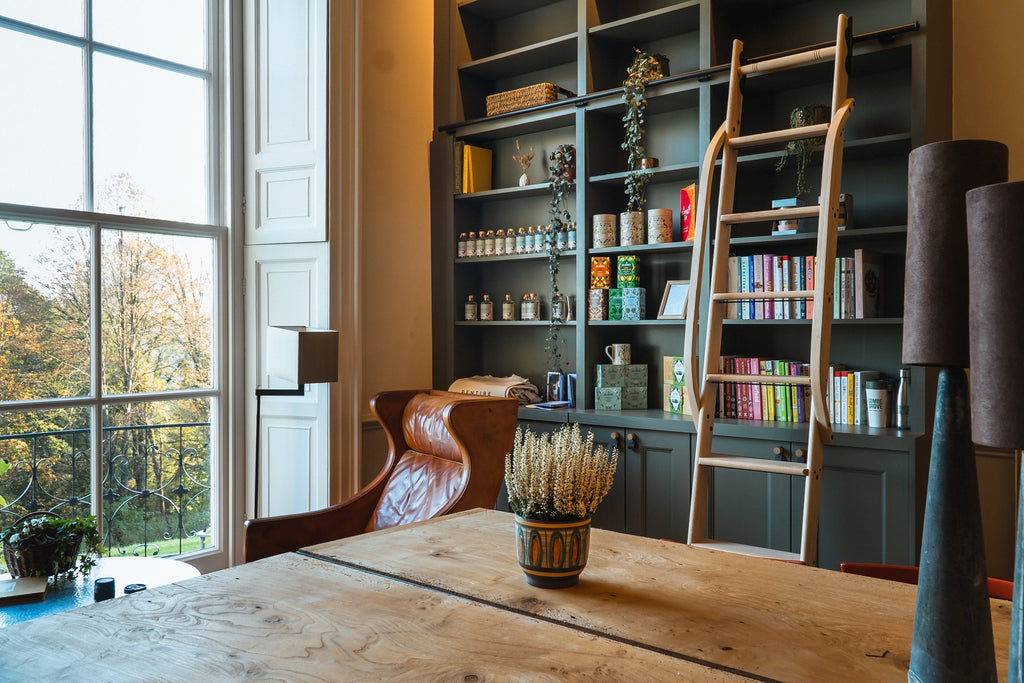 Rolling ladder in custom library joinery at Combe Grove retreat