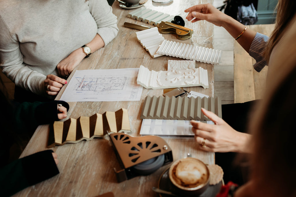 people sitting around a table doing some wall panelling project