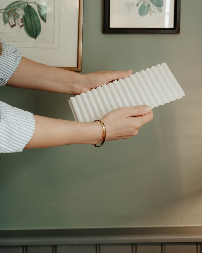 a person holding a wall panel