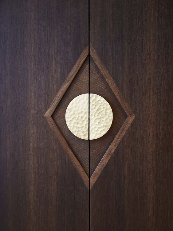 Hammered half circle handle on wooden door. 